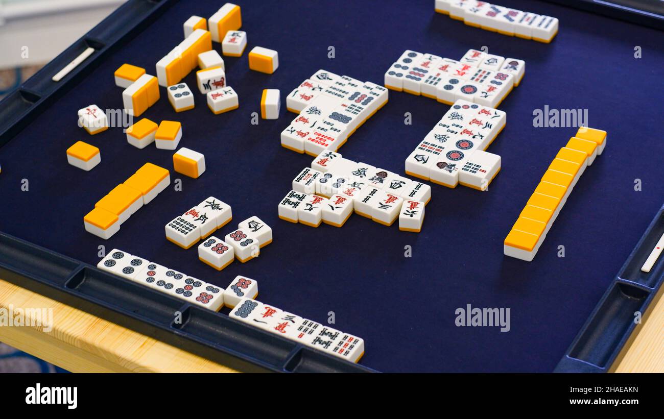 Many Mahjong tiles on on the playing field. An ancient asian game called Mahjong as a way to spend your free time with joy and get some fun. Mahjong t Stock Photo