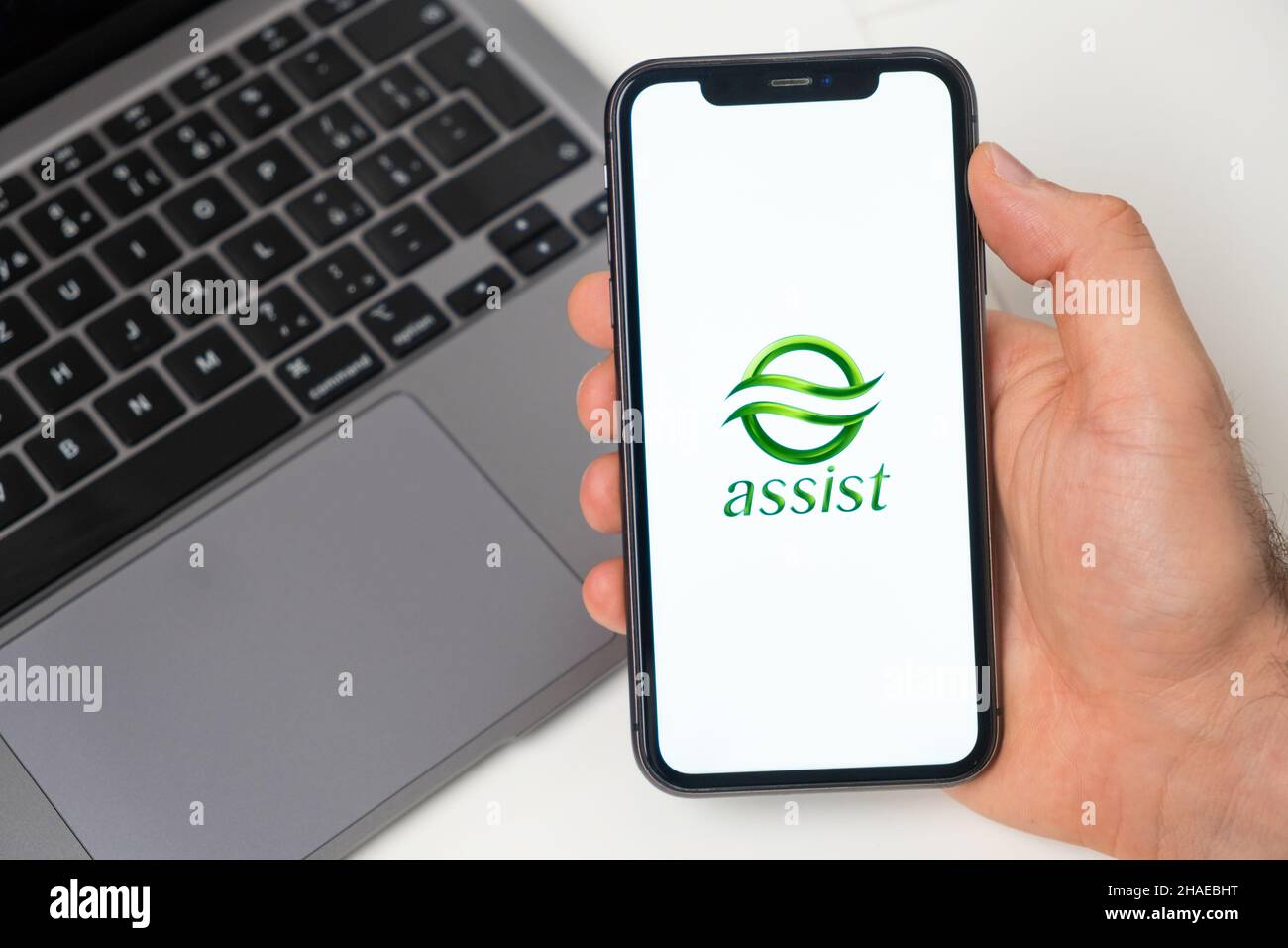 Assist crypto wallet logo on the screen of mobile phone and notebook on the background, November 2021, San Francisco, USA. November 2021, San Francisco, USA Stock Photo