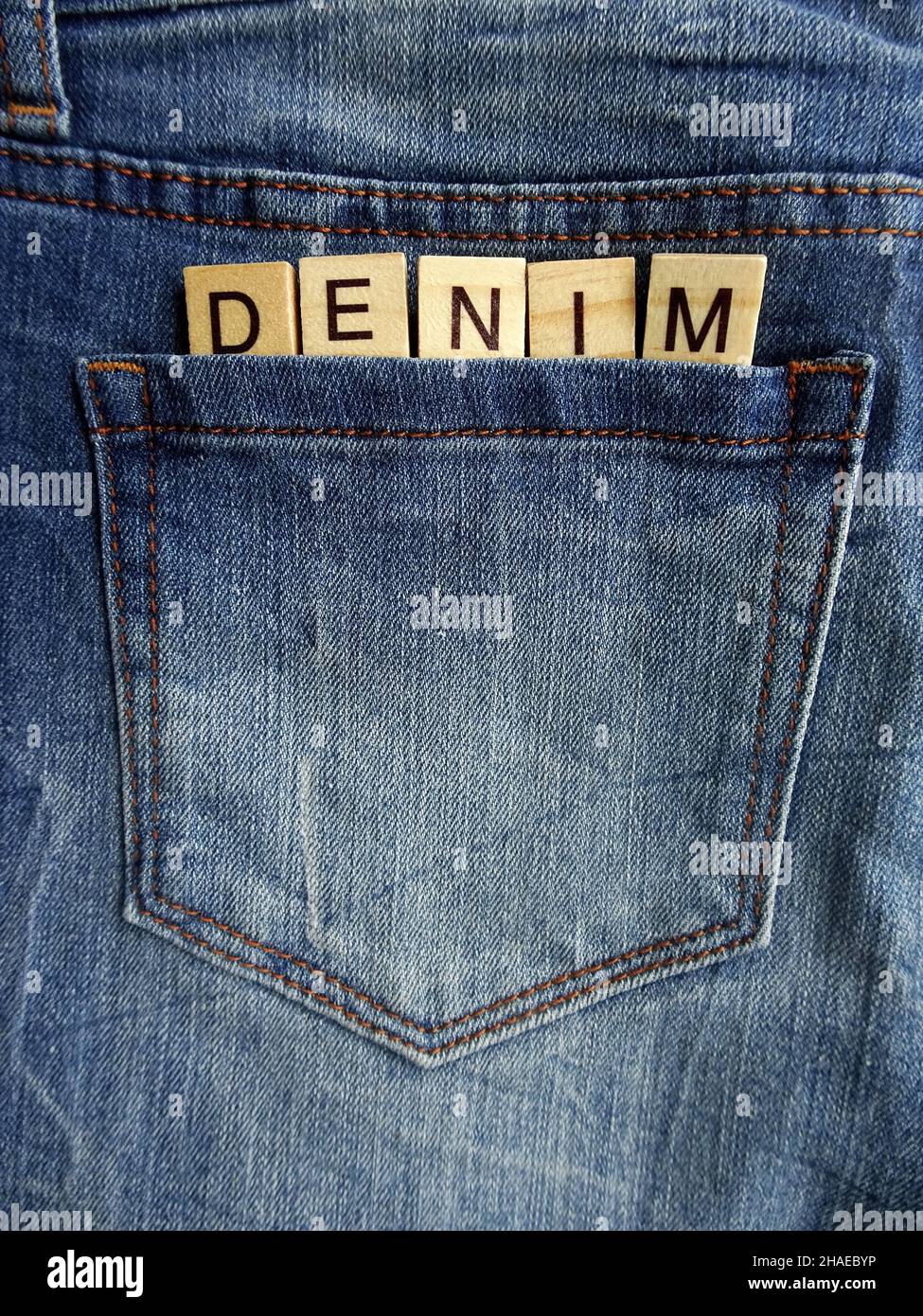 Word DENIM in jeans pocket, denim jeans, sale concept Stock Photo