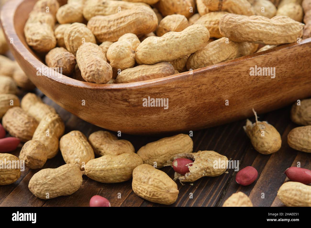 Raw organic peanuts in a wooden bowl. Stock Photo