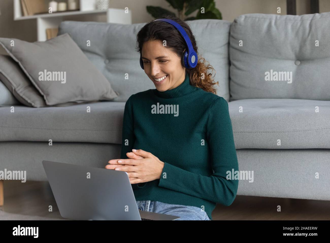 Happy Hispanic woman in headphones speak on video call Stock Photo - Alamy