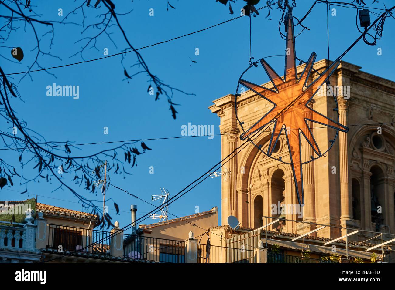 A walk in Granada: Plaza Bibrambla decorated with Christmas lighting with the cathedral in the background on a winter sunset Stock Photo