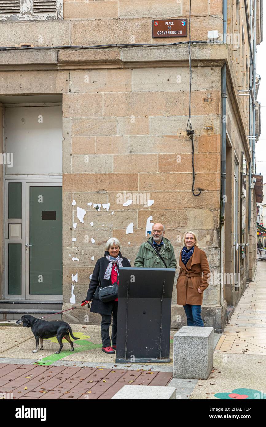 Angela Berg with Michel Bezacier and his wife at Place de Grevenbroich in downtown Saint Chamond, France. Grevenbroich, in Germany and Saint-Chamond in France are twin towns Stock Photo