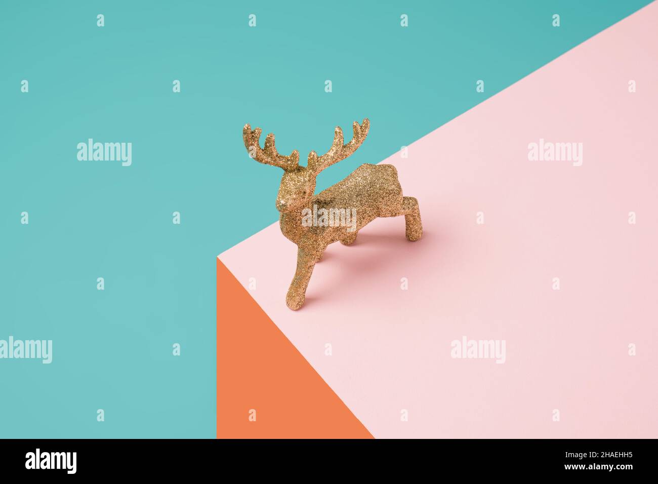 Christmas tree reindeer ornament on a geometric colorful background. Minimal winter holiday concept Stock Photo