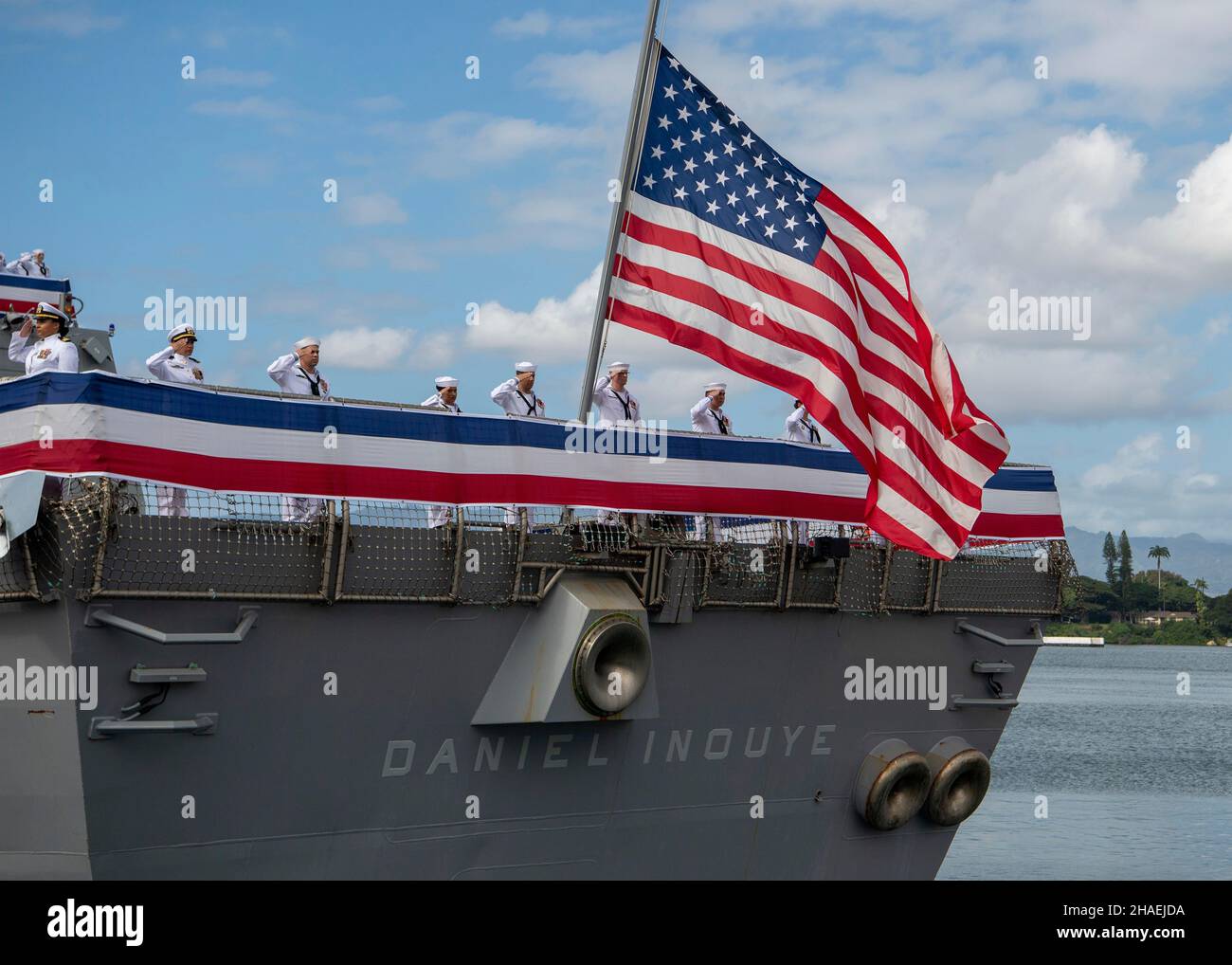 Pearl Harbor, United States. 08 December, 2021. U.S. Navy sailors man the rails during the commissioning ceremony for the newest guided-missile destroyer, USS Daniel Inouye at Joint Base Pearl Harbor-Hickam, December 8, 2021 in Honolulu, Hawaii. The warship honors former U.S. Senator and Medal of Honor recipient Daniel Inouye. Credit: MC2 Nick Bauer/U.S. Navy/Alamy Live News Stock Photo