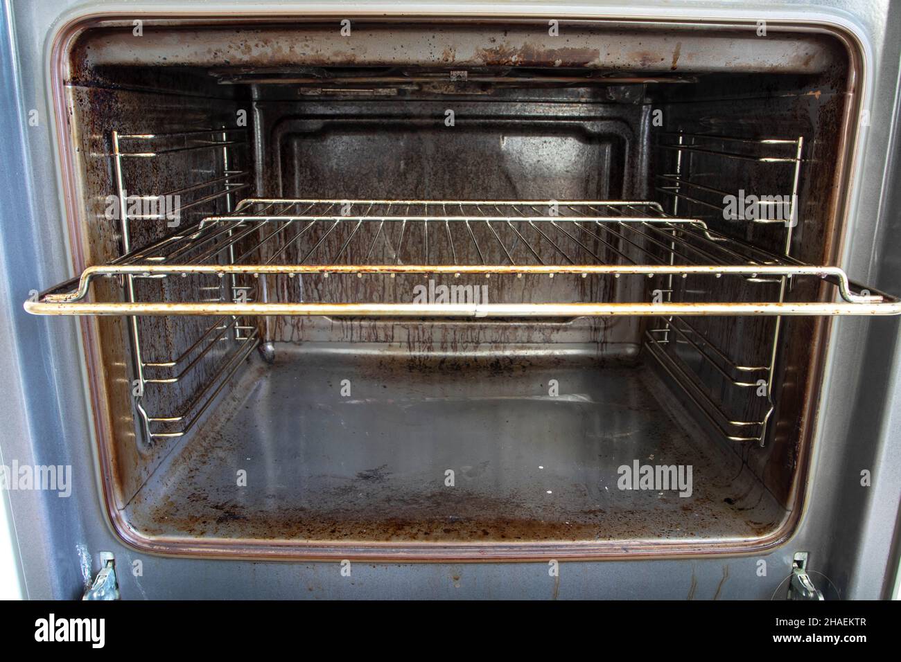 Very dirty oven. What needs to be done in the kitchen. Home imperfections. Motivation to clean. Stock Photo