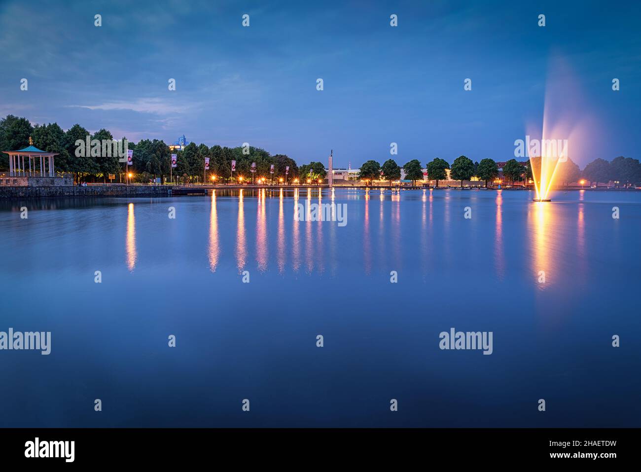 A scenic view at the Masch lake with lights and sky reflecting on the surface in Hanover, Germany Stock Photo