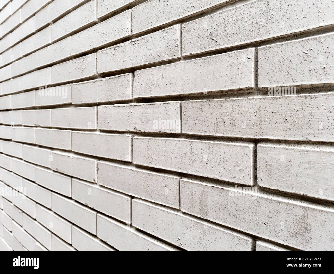 weathered textured white brick wall perspective view Stock Photo