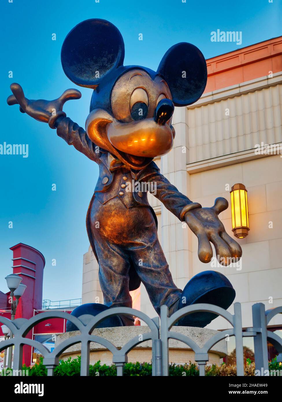 Paris, France - April 2019: Statue of mickey mouse against light blue sky background at disneyland funfair Stock Photo