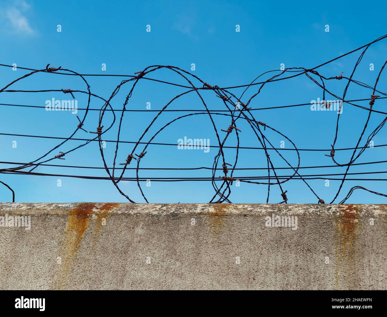 Concrete wall with barbed wire, the concept of prison, salvation, Refugee, lonely, copy space Stock Photo