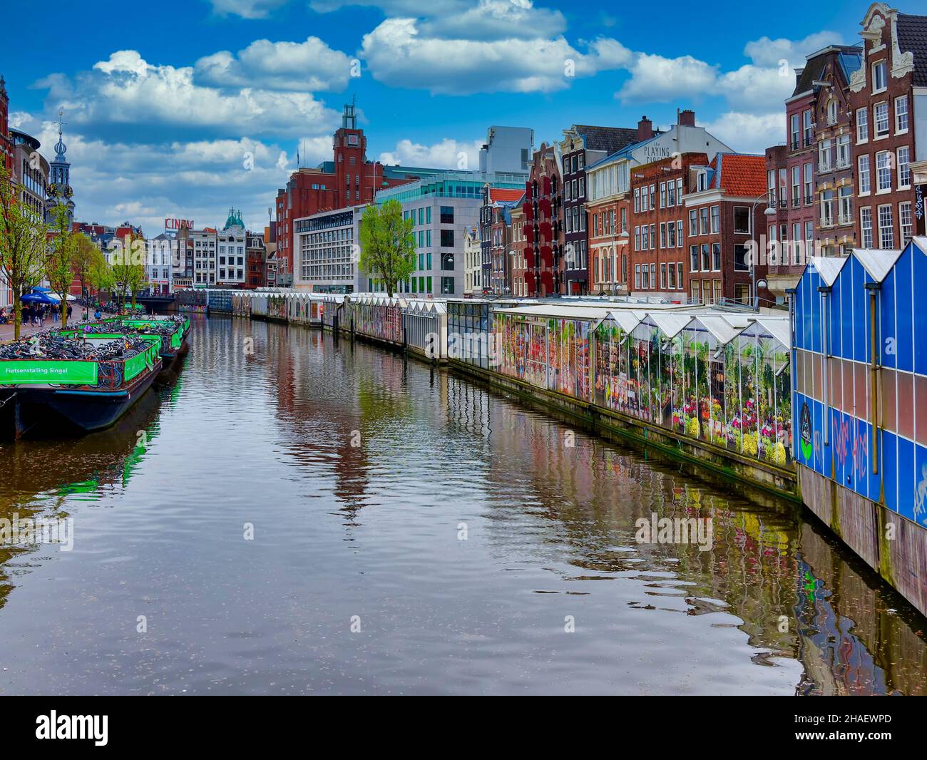 Amsterdam, The Netherlands - may 2021 - Amsterdam street traditional ancient dutch colorful buildings and flower market on Single canal in Amsterdam, Stock Photo