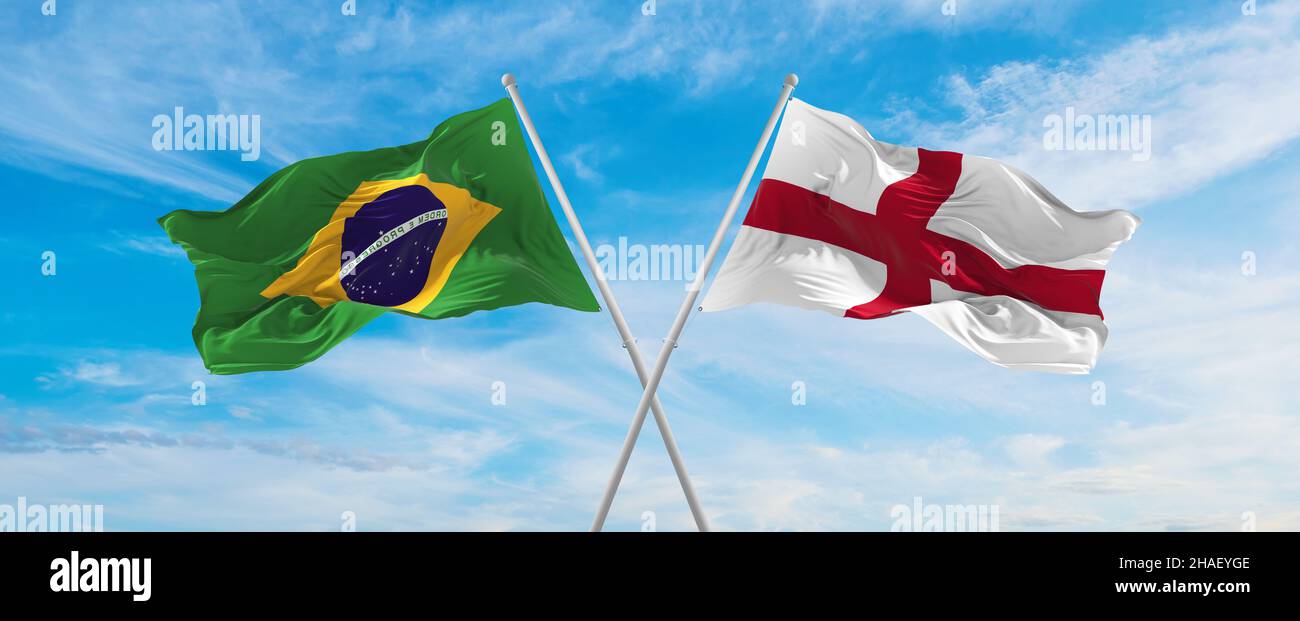 crossed national flags of Brazil and England flag waving in the wind at ...
