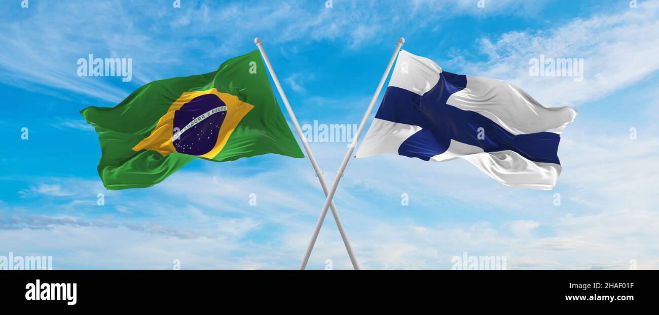 crossed national flags of Brazil and Finland flag waving in the wind at ...