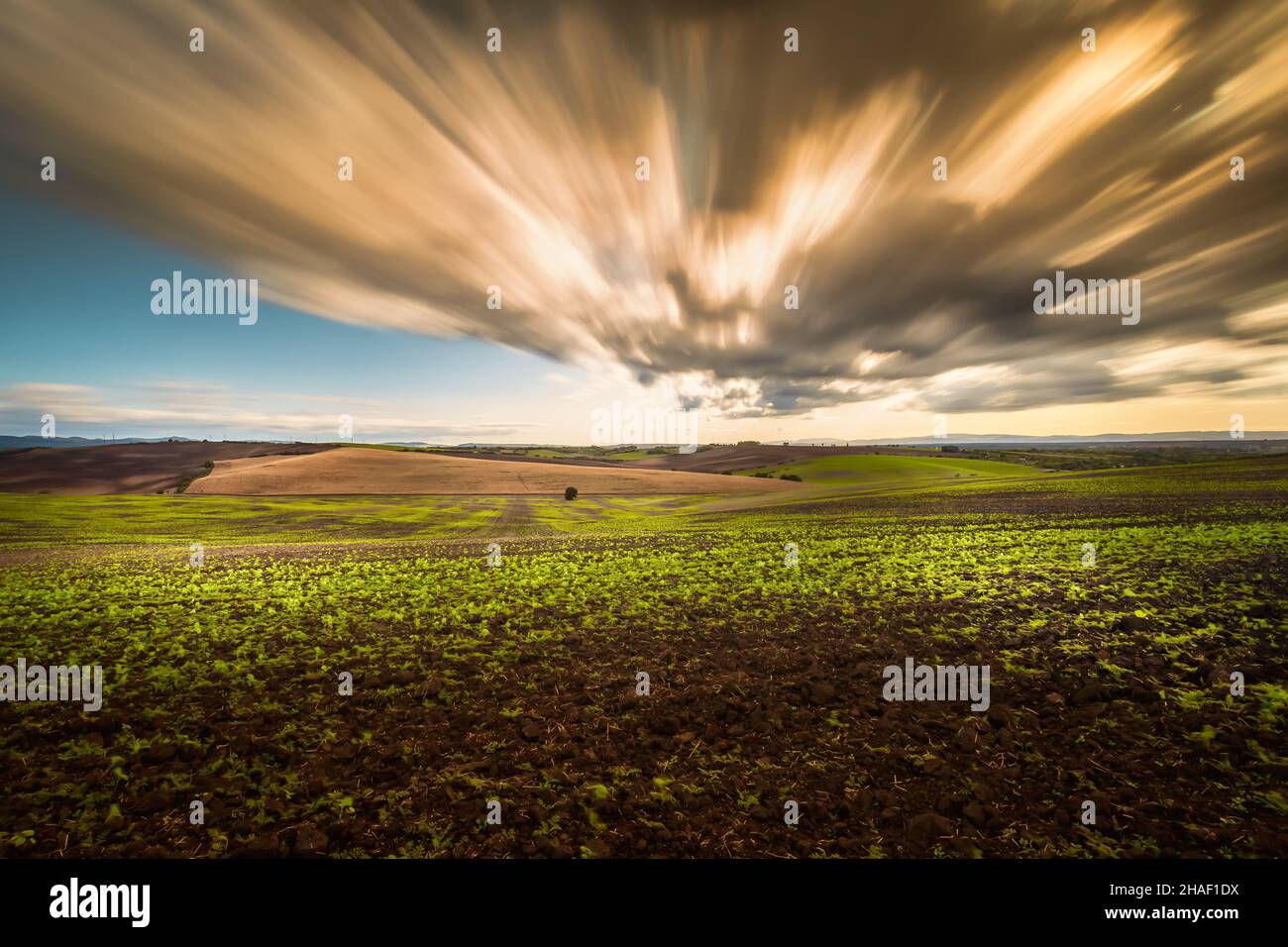 Rolling fields of South Moravia in the autumn morning with a sky full of fast-moving clouds after a storm, Moravian Tuscany, Czechia Stock Photo
