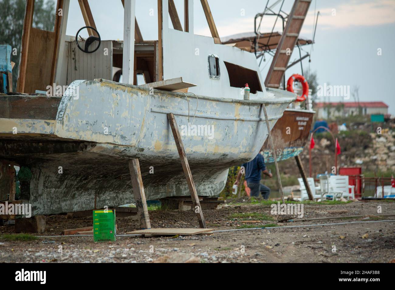 A boat landed for repair Stock Photo - Alamy