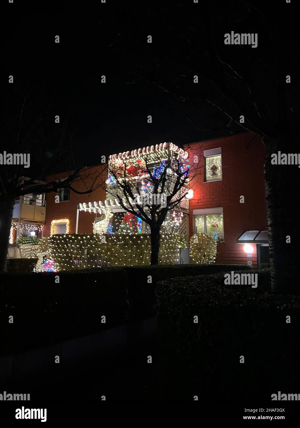 Christmas lights on balconies, windows and hedges in residential