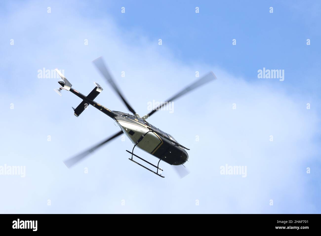 A helicopter flying in the sky in the daytime Stock Photo - Alamy