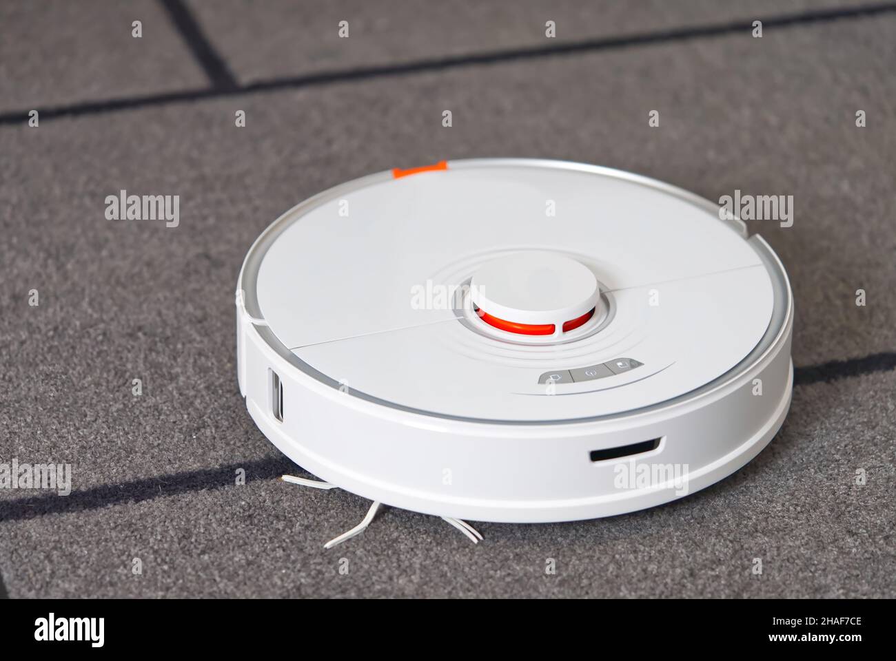robot vacuum cleaner performs automatic cleaning on carpet Stock Photo ...