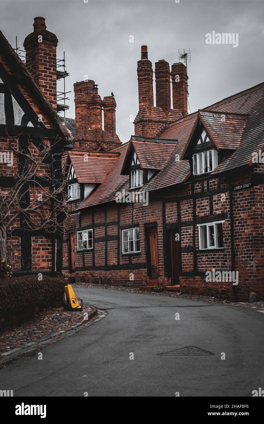 Gloomy tudor street in a small Cheshire village in Autumn. Great Budworth is a village and civil parish in Cheshire, England, United Kingdom. Stock Photo