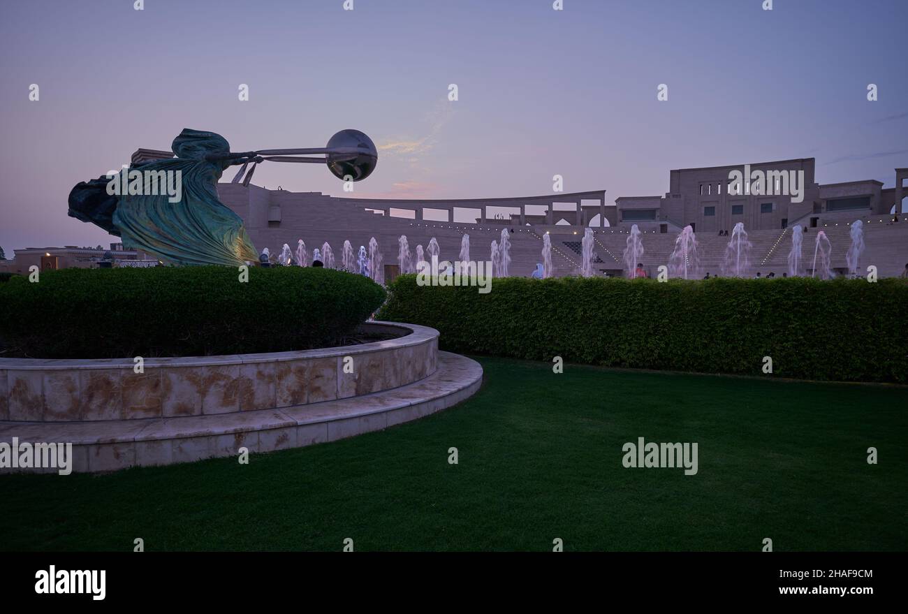 Katara Cultural village in Doh , Qatar with Force of Nature 2 statue in foreground and the Amphitheater in the background Stock Photo