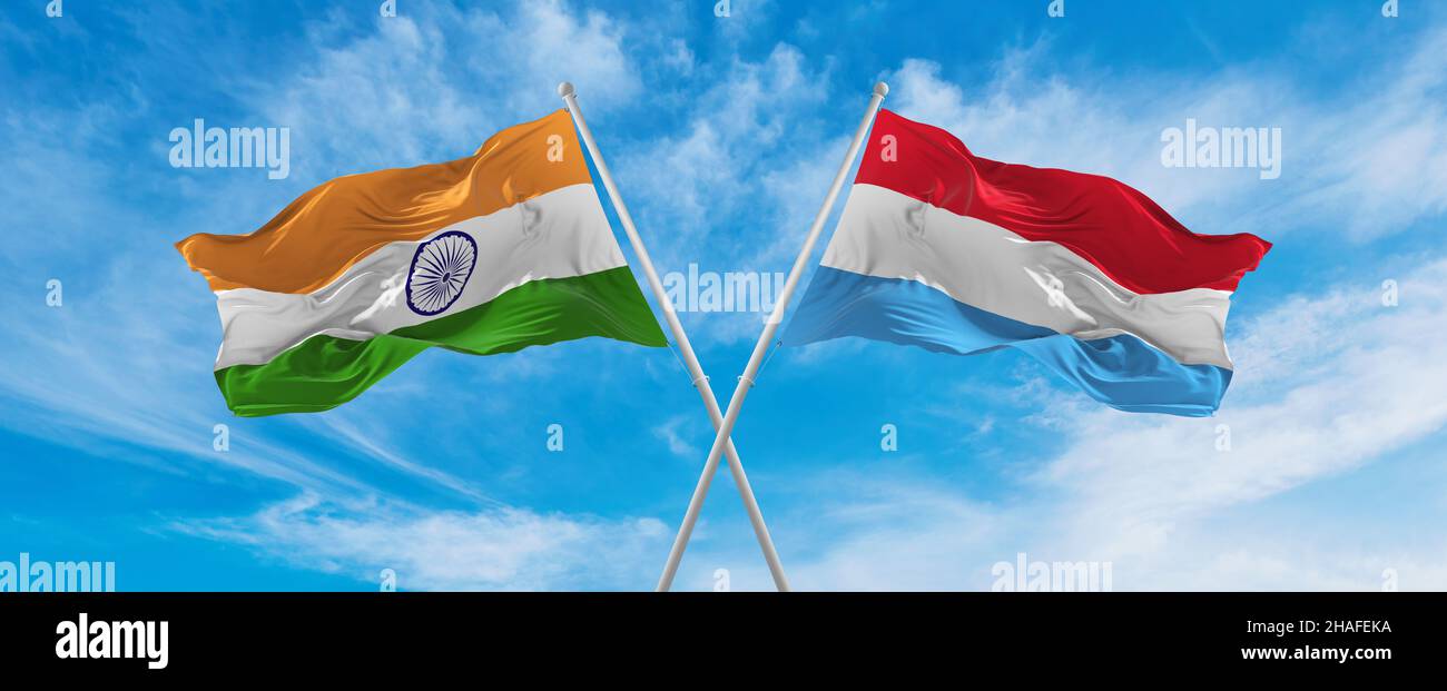 crossed national flags of India and Luxembourg flag waving in the wind ...