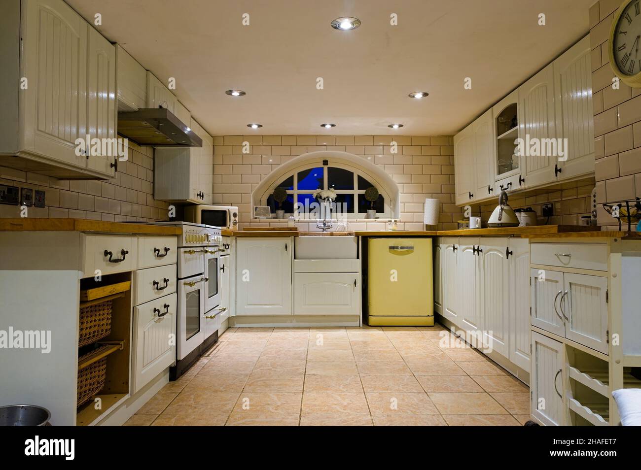 Retro style basement kitchen with modern appliances and ceiling spot lighting Stock Photo