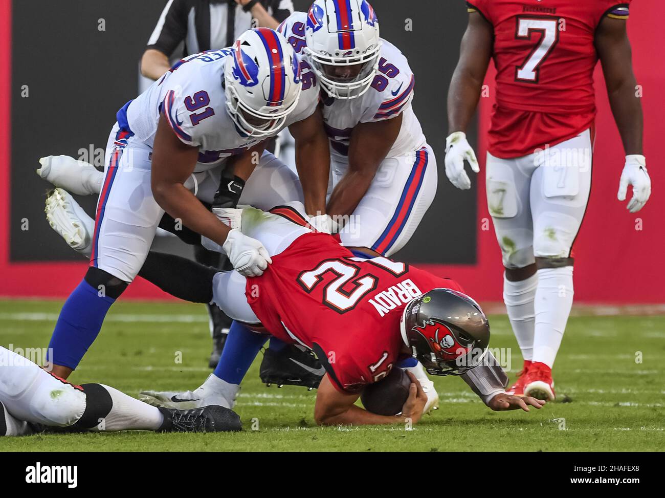 Tampa, United States. 12th Dec, 2021. Buffalo Bills' Ed Oliver (91) and Jerry Hughes (55) upend Tampa Bay Buccaneers quarterback Ton Brady (12) during the first half at Raymond James Stadium in Tampa, Florida on Sunday, December 12, 2021. Photo by Steve Nesius/UPI Credit: UPI/Alamy Live News Stock Photo