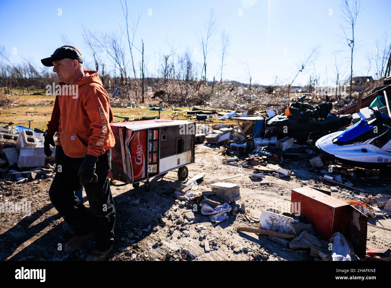 A Coke machine is removed from a home of a man who died after a tornado tore through rural
