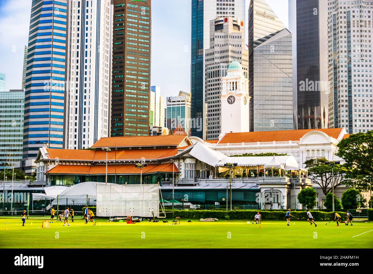 Foot ball activity on Padang field, with Singapore Cricket Club in the background Stock Photo