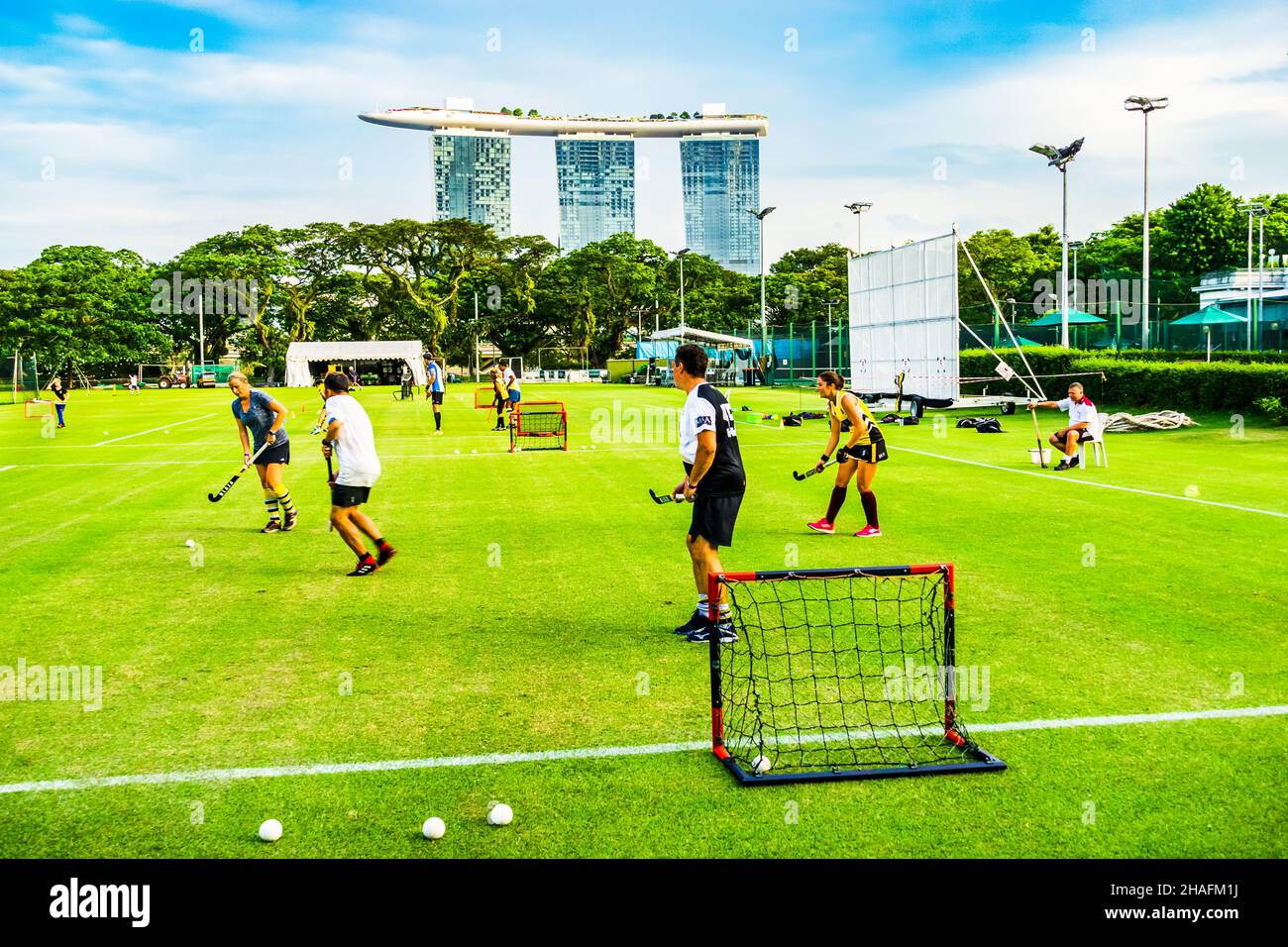 Field hockey on Padang, with Marina Bay Sands in the background. Stock Photo