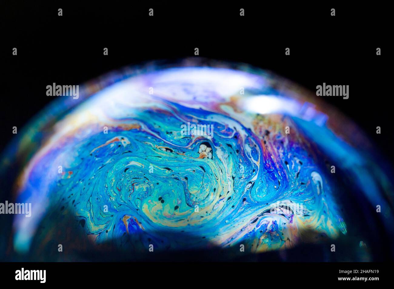 Abstract pattern, multicolored chaotic texture inside of the soap bubble, closeup Stock Photo
