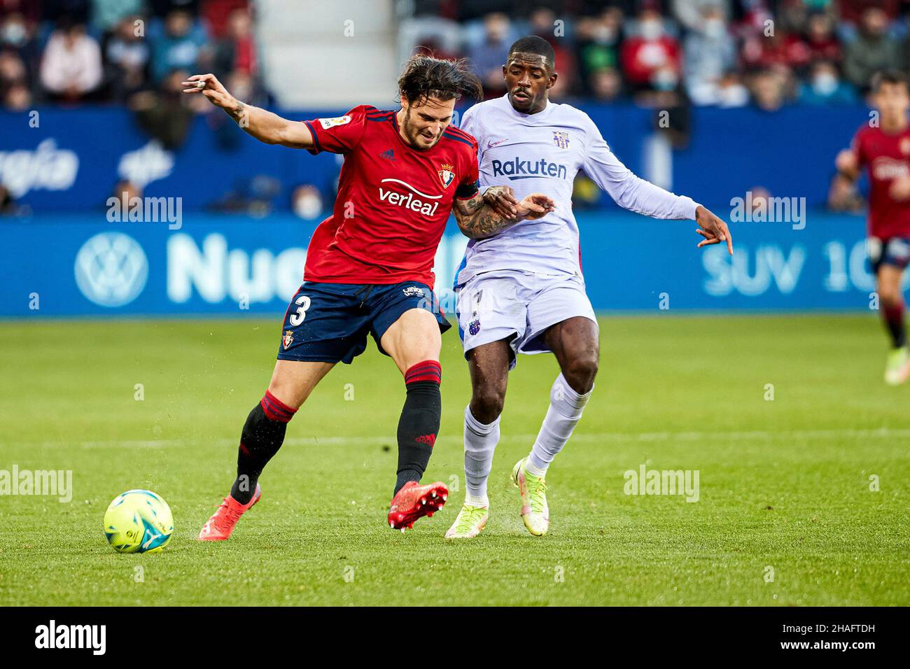 Pamplona, Spain. 12th Dec, 2021. Juan Cruz (L), defender of CA Osasuna, and Ousmane Dembelé (R), forward of FC Barcelona are seen in action during the Spanish football of La Liga Santander, the match between CA Osasuna and FC Barcelona at the Sadar stadium in Pamplona.(Final score; CA Osasuna 2:2 FC Barcelona) Credit: SOPA Images Limited/Alamy Live News Stock Photo