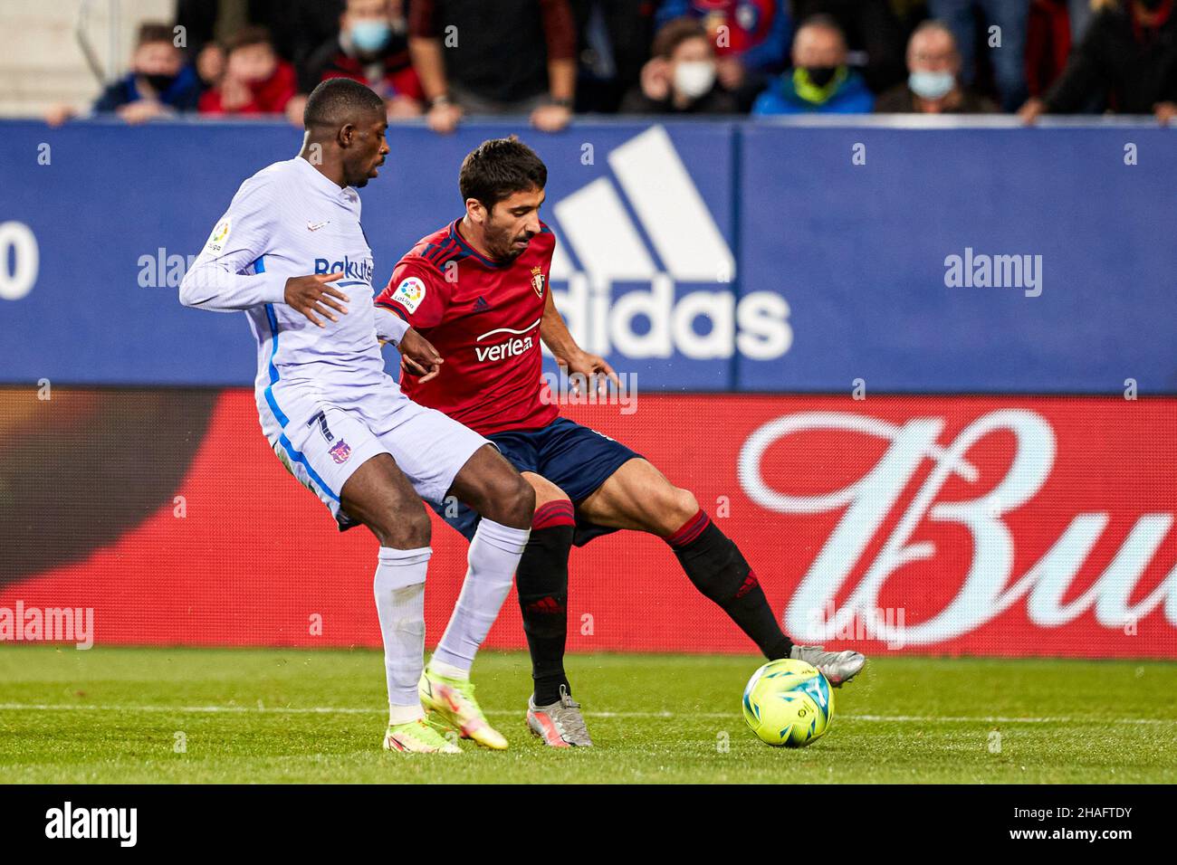 Pamplona, Spain. 12th Dec, 2021. Jose Angel Valdes 'Cote' (R), defender of CA Osasuna and Ousmane Dembelé (L), forward of FC Barcelona are seen in action during the Spanish football of La Liga Santander, the match between CA Osasuna and FC Barcelona at the Sadar stadium in Pamplona.(Final score; CA Osasuna 2:2 FC Barcelona) Credit: SOPA Images Limited/Alamy Live News Stock Photo