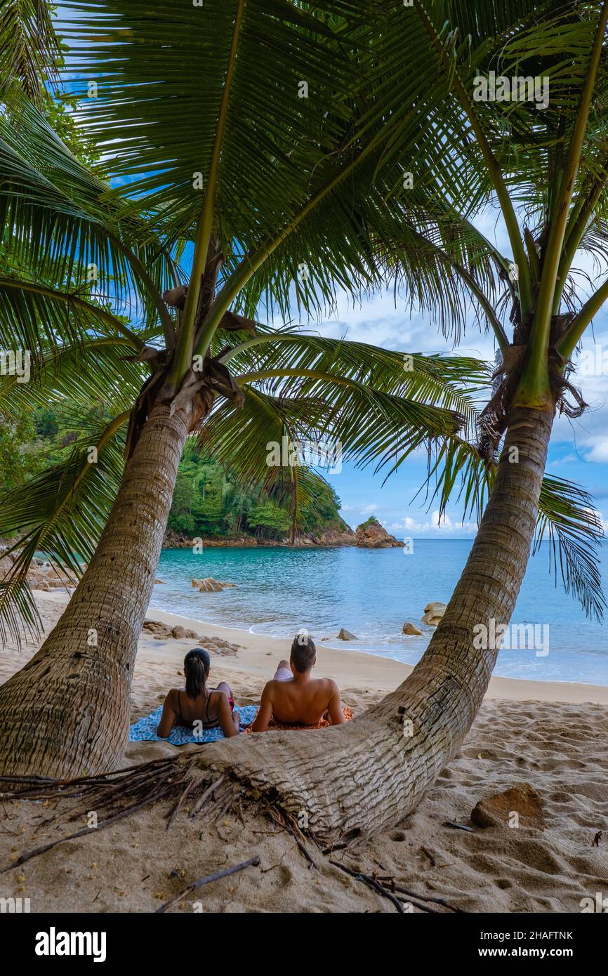 Banana beach Phuket Thailand, tropical beach with palm trees in Phuket Thailand. couple man and woman at banana beach Phuket Stock Photo