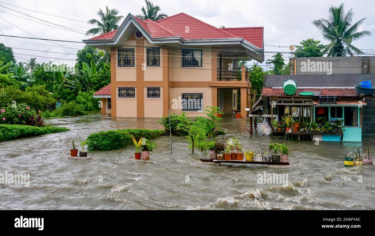 Baco, Oriental Mindoro, Philippines - July 23, 2021. Heavy monsoon rain linked to Typhoon In-fa causes severe flooding on property near Calapan City. Stock Photo