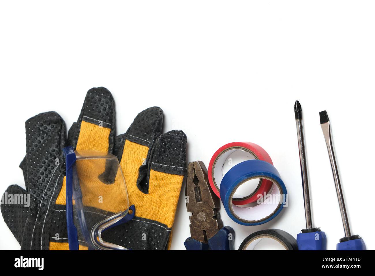 Tools of worker, on white background, screwdrivers, duct tape, pliers and safety glasses Stock