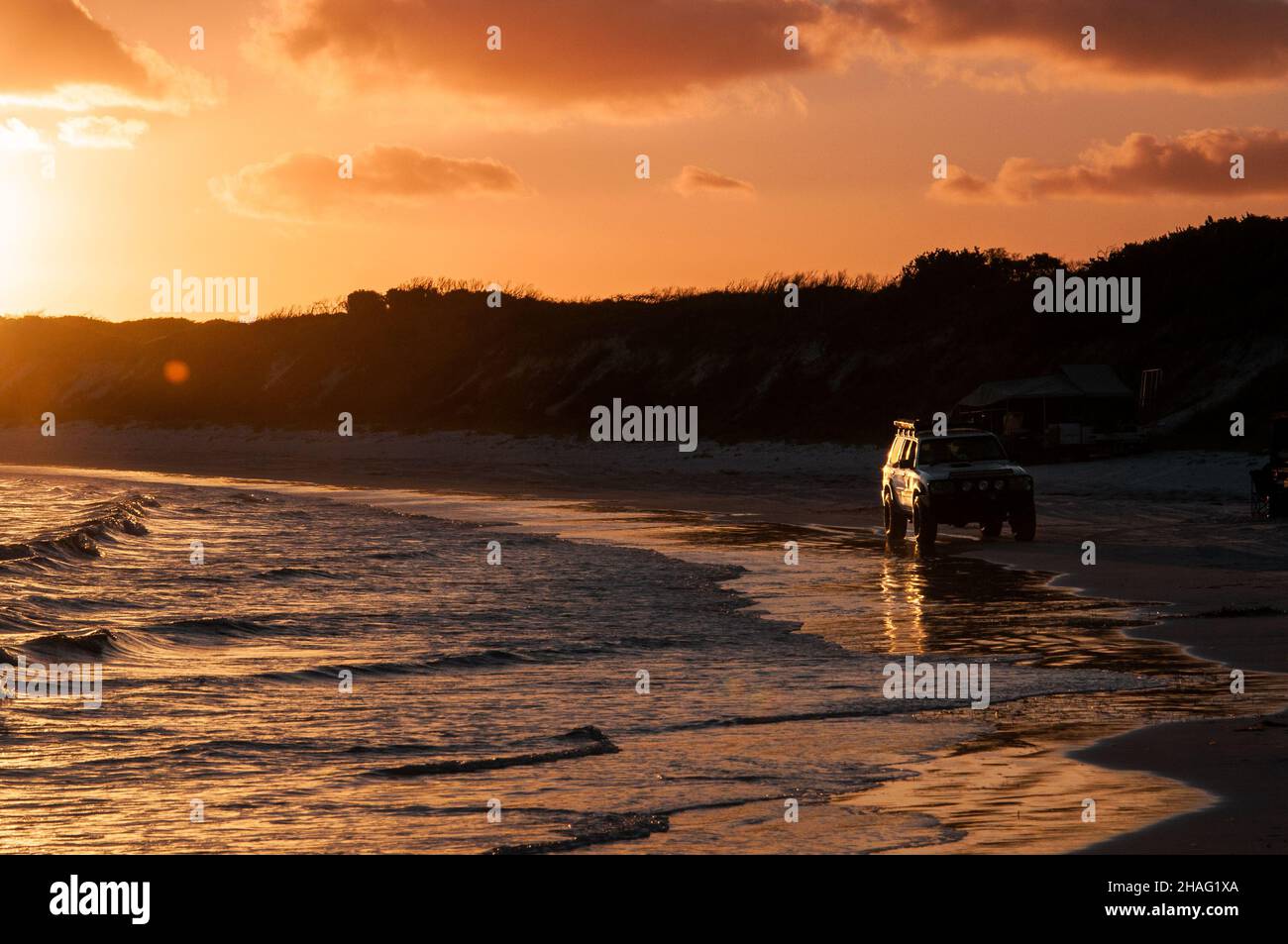 Iconic 4x4 driving on the Australian beach - camping. Stock Photo