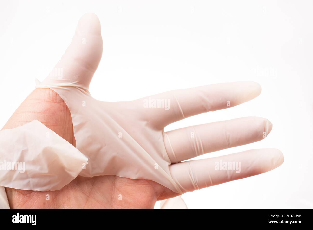 Hands closeup in torn rubber gloves. torn medical gloves after a