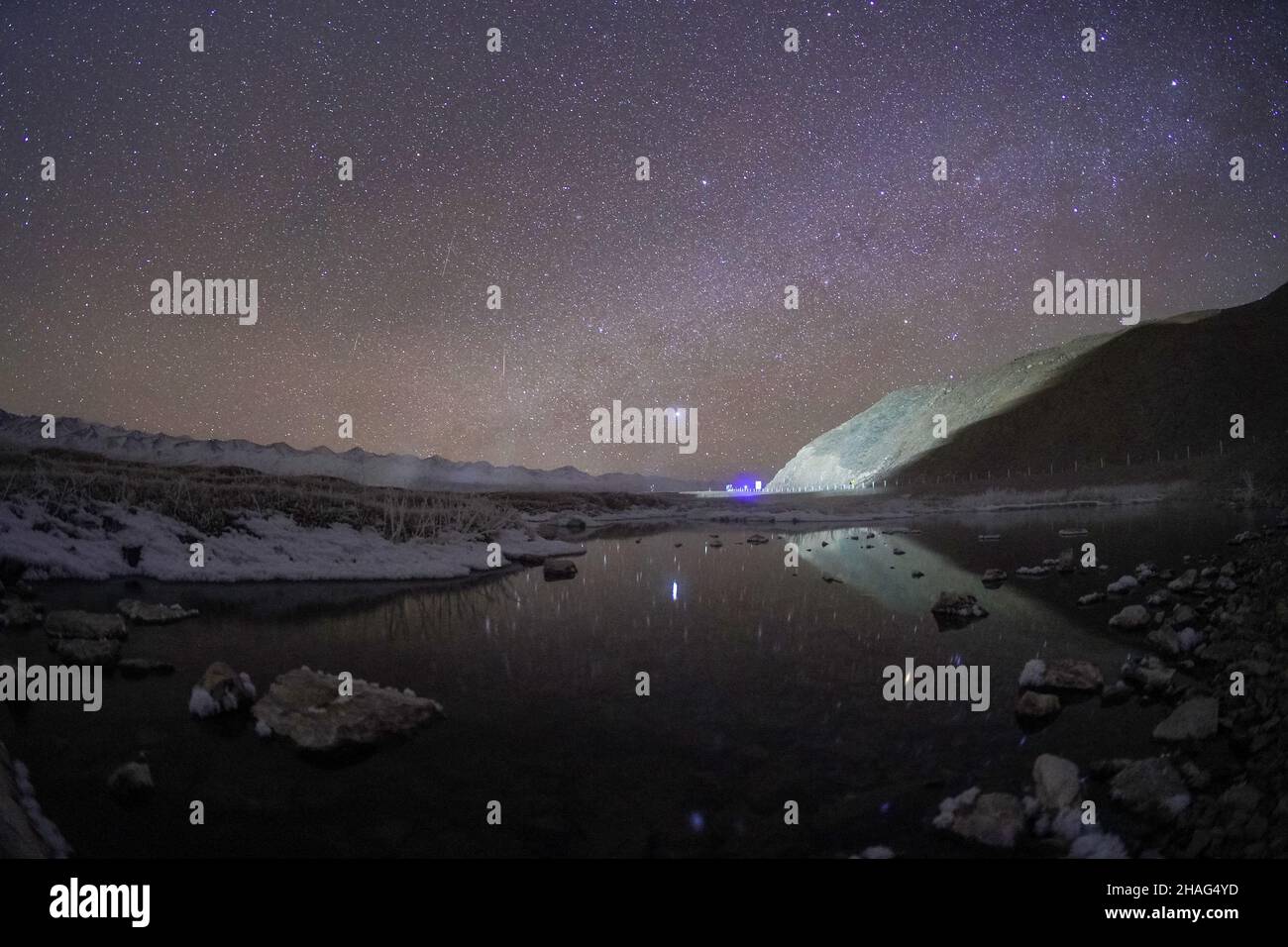 BAZHOU, CHINA - DECEMBER 12, 2021 - A Geminid meteor shower streaks across the night sky on the early morning of December 12, 2021, in Bazhou, Xinjian Stock Photo