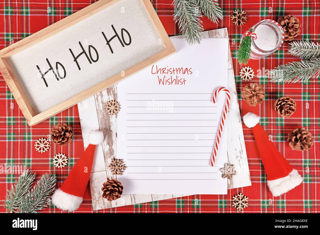Christmas wish list surrounded by seasonal decoration Stock Photo