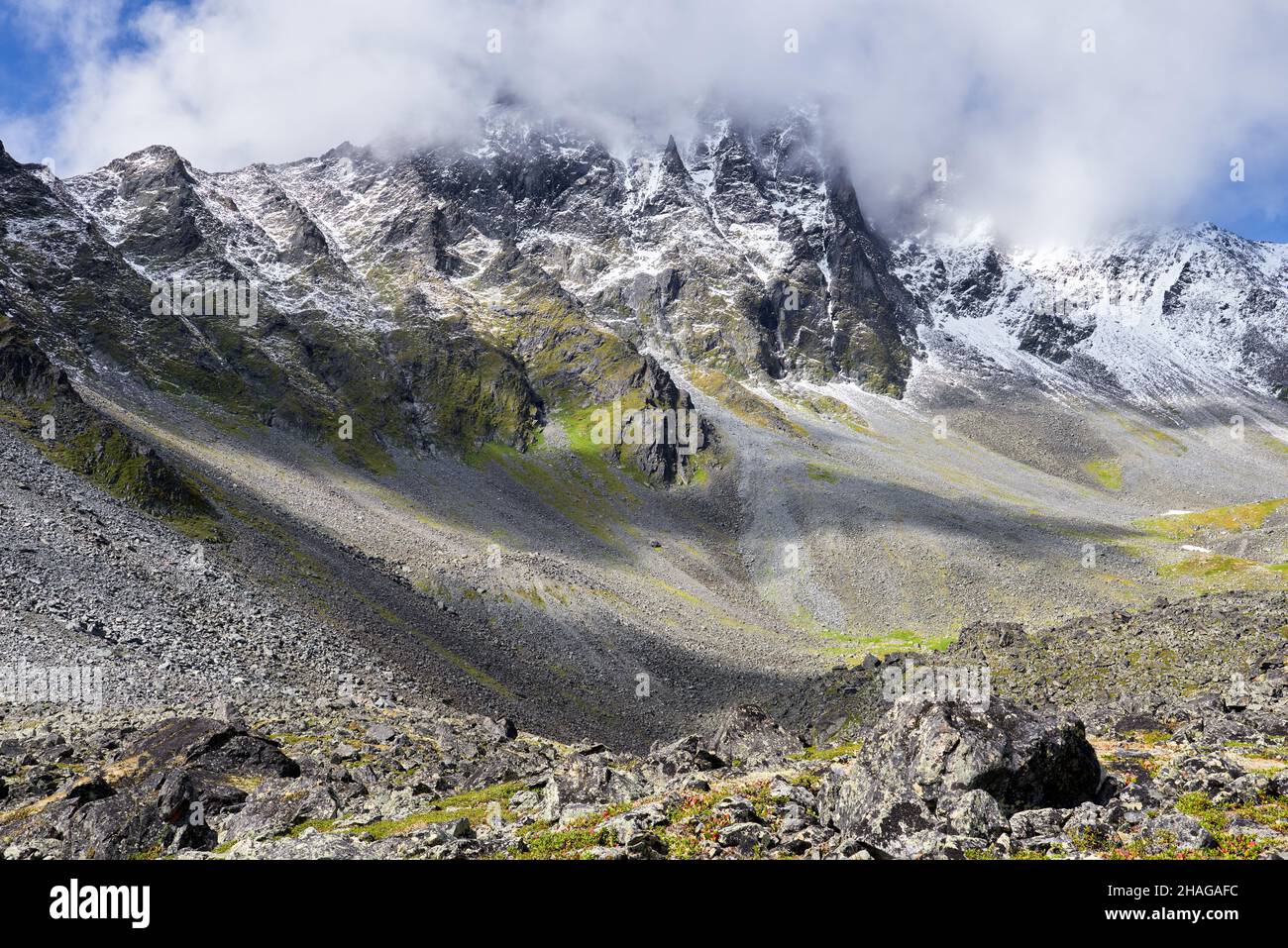 View of the mountain peak covered with clouds. Alpine landscape in East ...