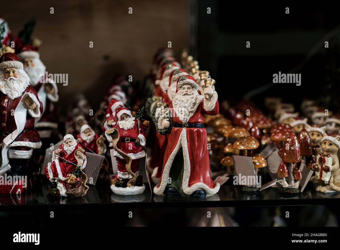 Many toys Santa Claus. Different colorful statuettes of  in souvenir shop. new year and christmas, winter holiday background Stock Photo