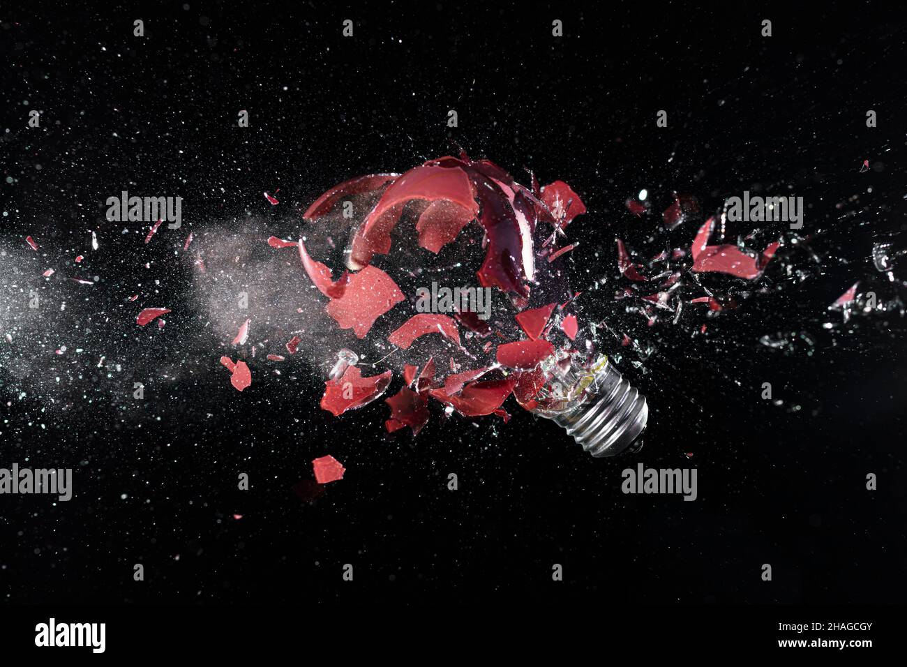impact explosion of a red light bulb on black Stock Photo