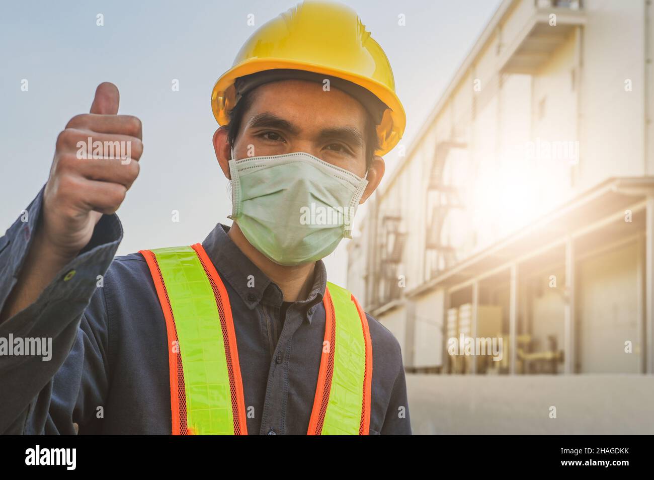 Engineer standing factory plant background , Technician workplace manufacturing maintenance facility Stock Photo