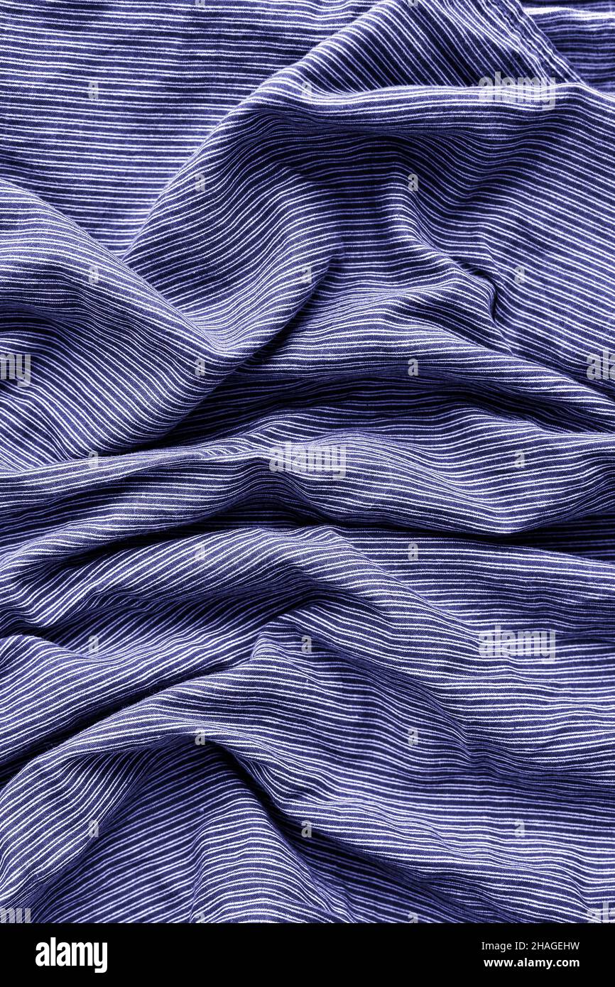 Very peri color of the year 2022. Striped fabric. Cotton, bedding, blue and white stripes on the fabric. Texture. Background. Stock Photo