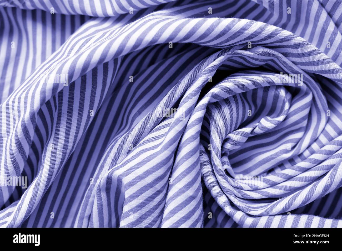 Very peri color of the year 2022. Striped fabric. Cotton, bedding, blue and white stripes on the fabric. Texture. Background. Stock Photo