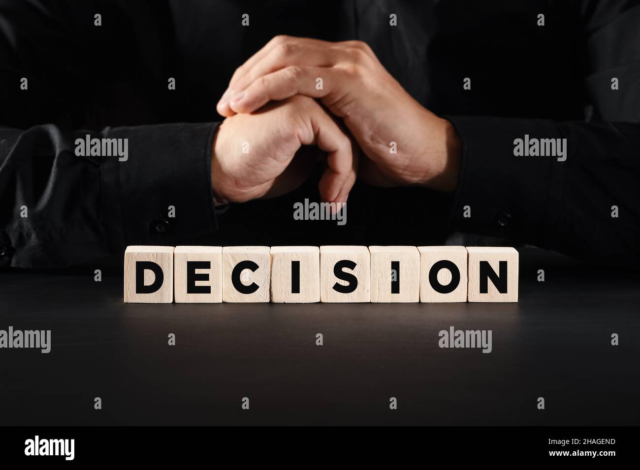 The word decision on wooden blocks with a business person background ...
