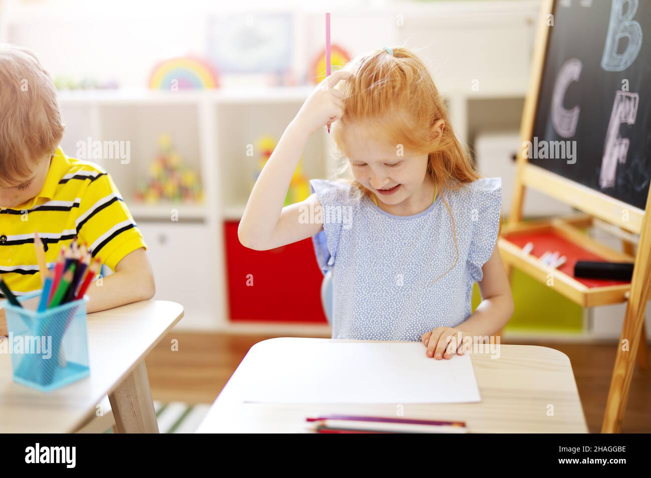 Cute girl sitting in the classroom and thinking over a task Stock Photo ...