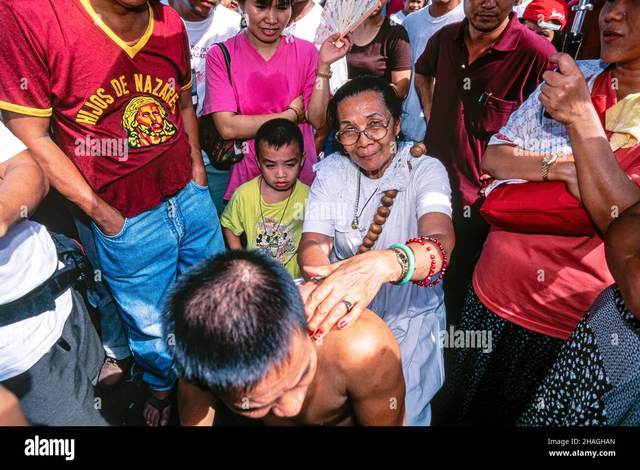 Traditional faith healer laying hands on a patient, Quiapo, Manila, Philippines Stock Photo