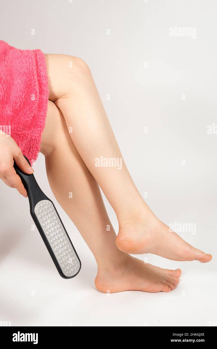 Woman Using Foot File For Removing Dead Skin From Feet In Bathroom Closeup  Stock Photo - Download Image Now - iStock